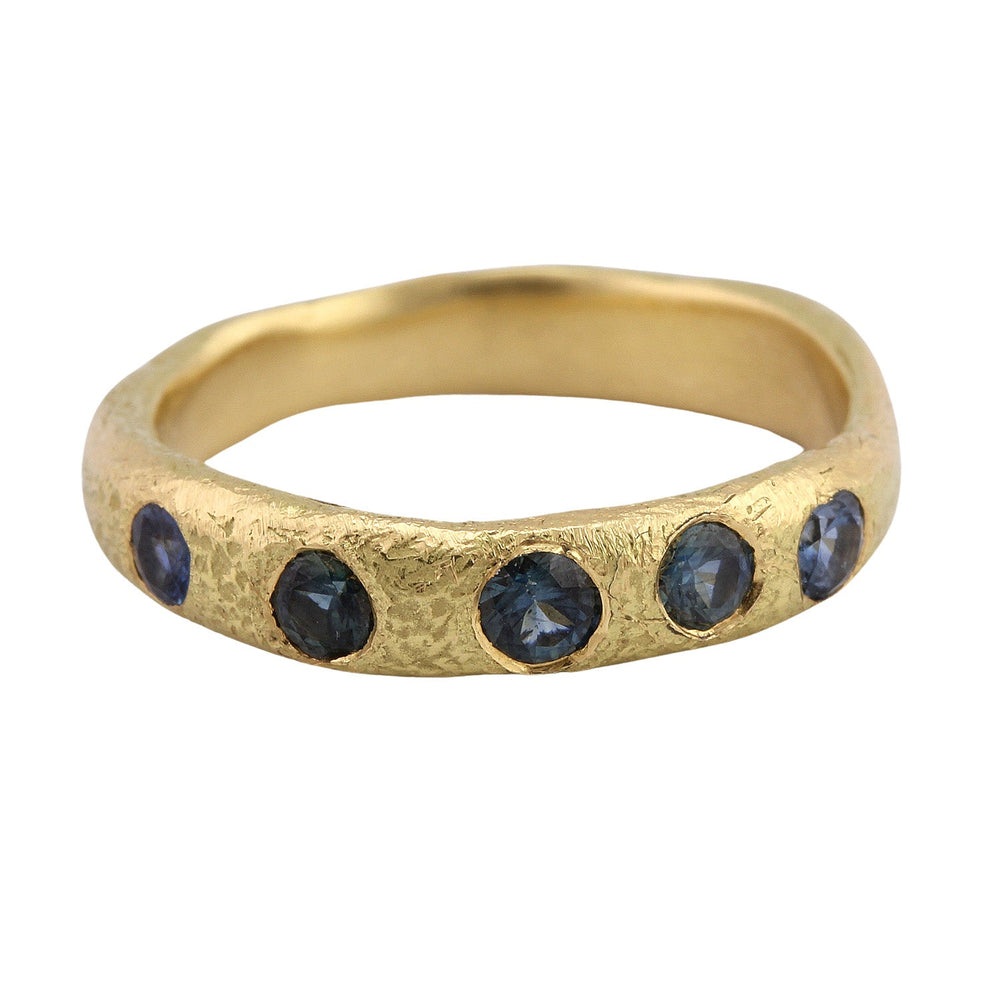 
                      
                        Angled view of Narrow Molten Band in 18k yellow gold with blue-green sapphires by Betsy Barron
                      
                    