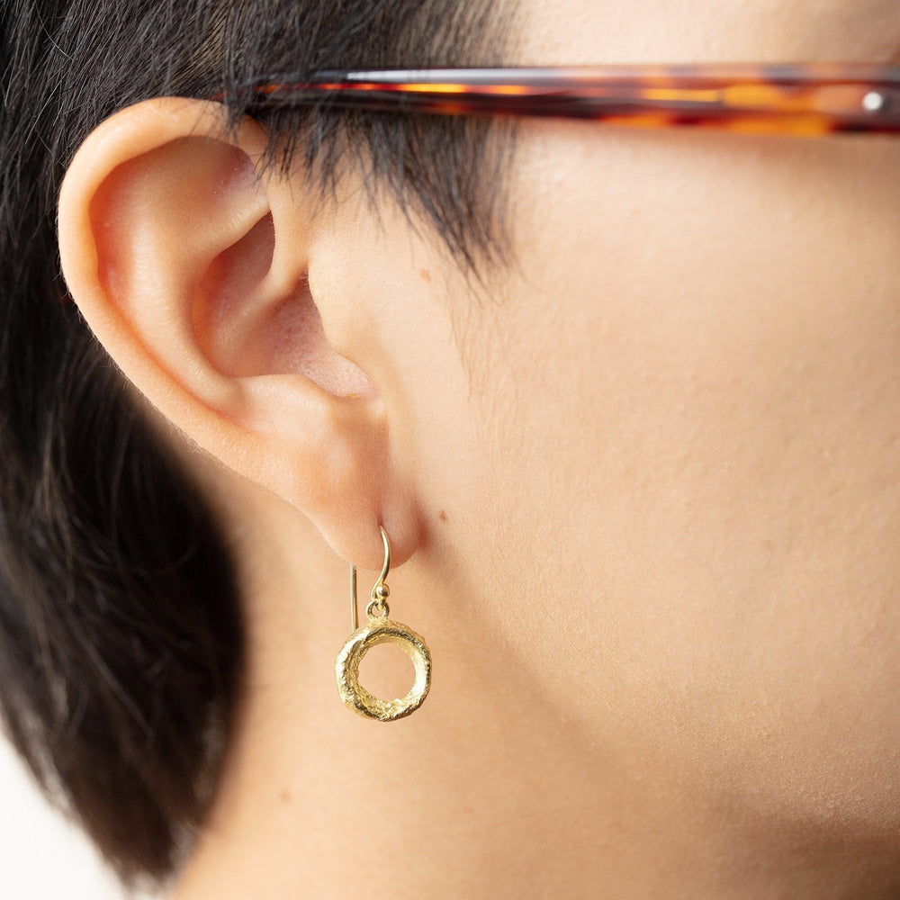 
                      
                        Detail view of model wearing 18k yellow gold Organic Donut Earring in right ear.
                      
                    