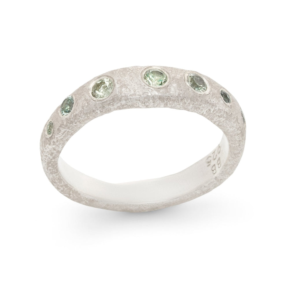 
                      
                        Angled view of Narrow Molten Band in Sterling Silver with green sapphires by Betsy Barron
                      
                    