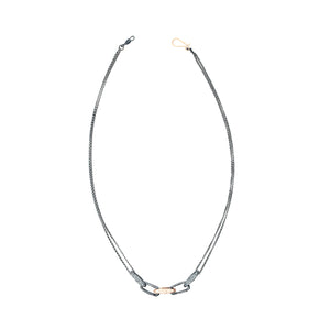 Top-down view of Sterling Silver Desi Necklace with one 14k Rose Gold Link