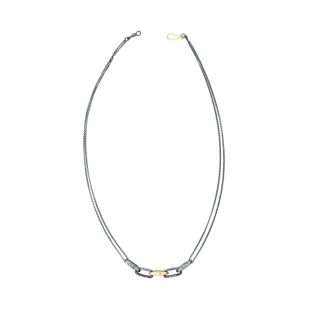 Top-down view of Sterling Silver Desi Necklace with one 18k Yellow Gold Link